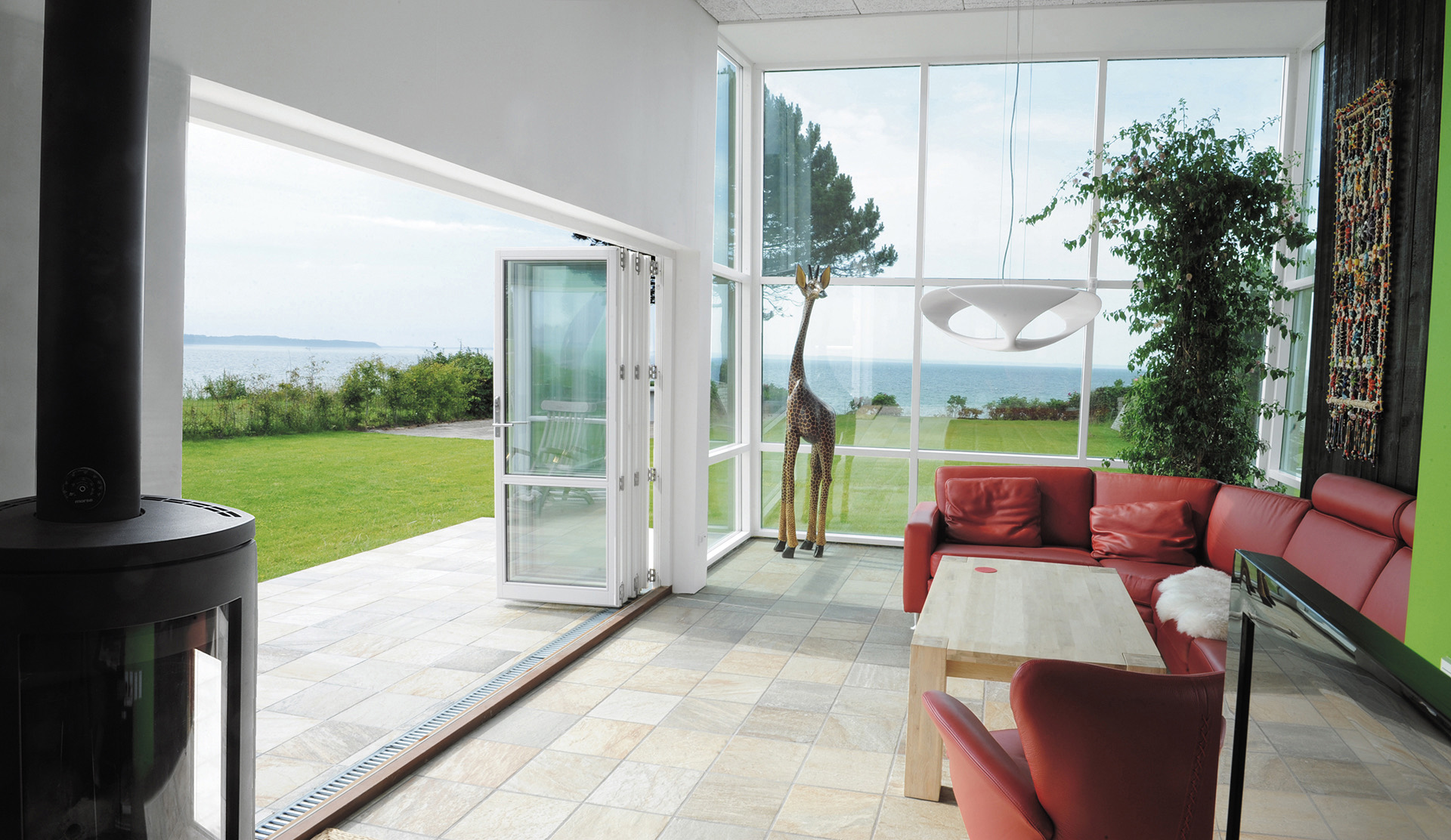 Timber bifold doors folded back onto a paved terrace