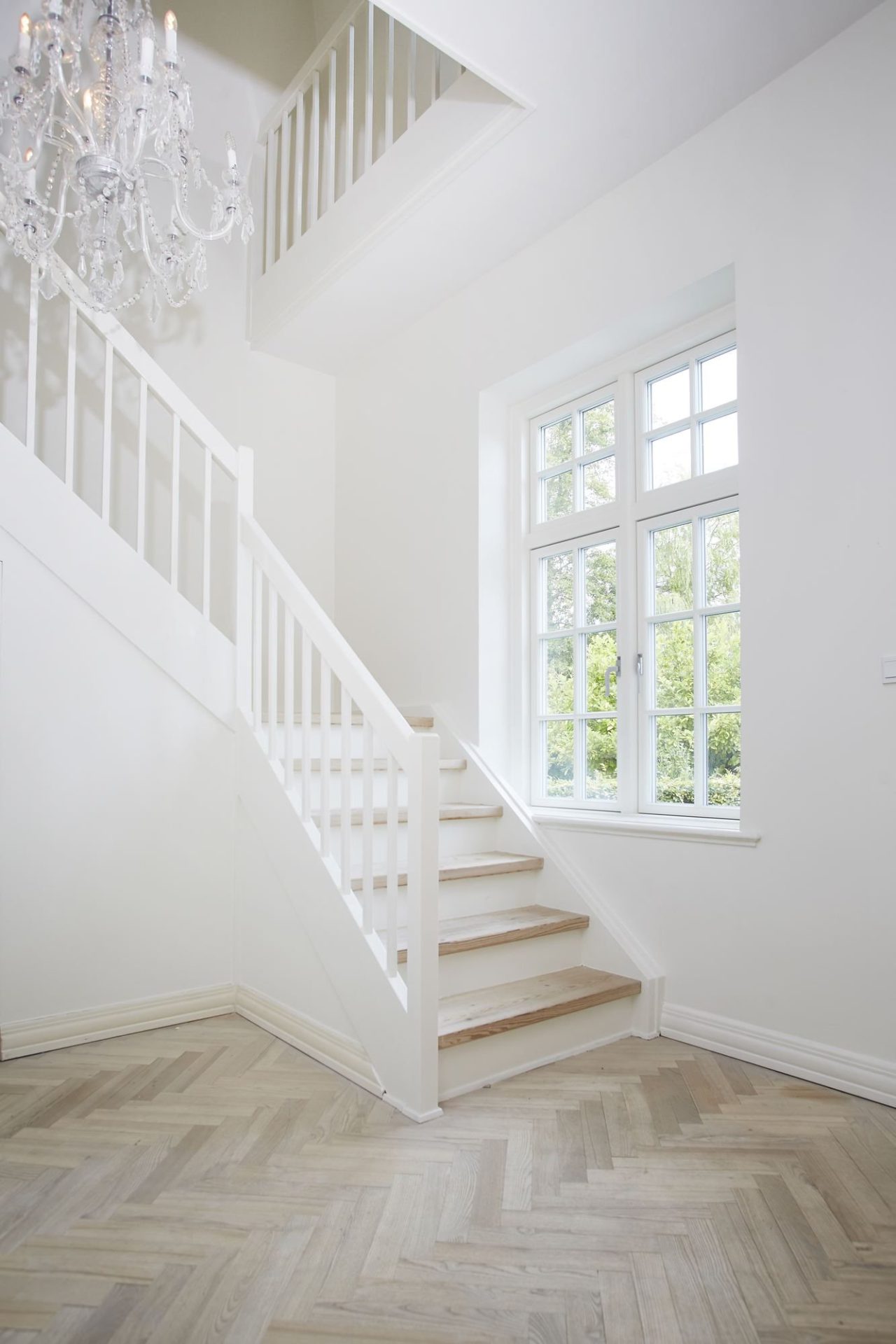 White painted VELFAC Classic window with glazing bars beside a staircase