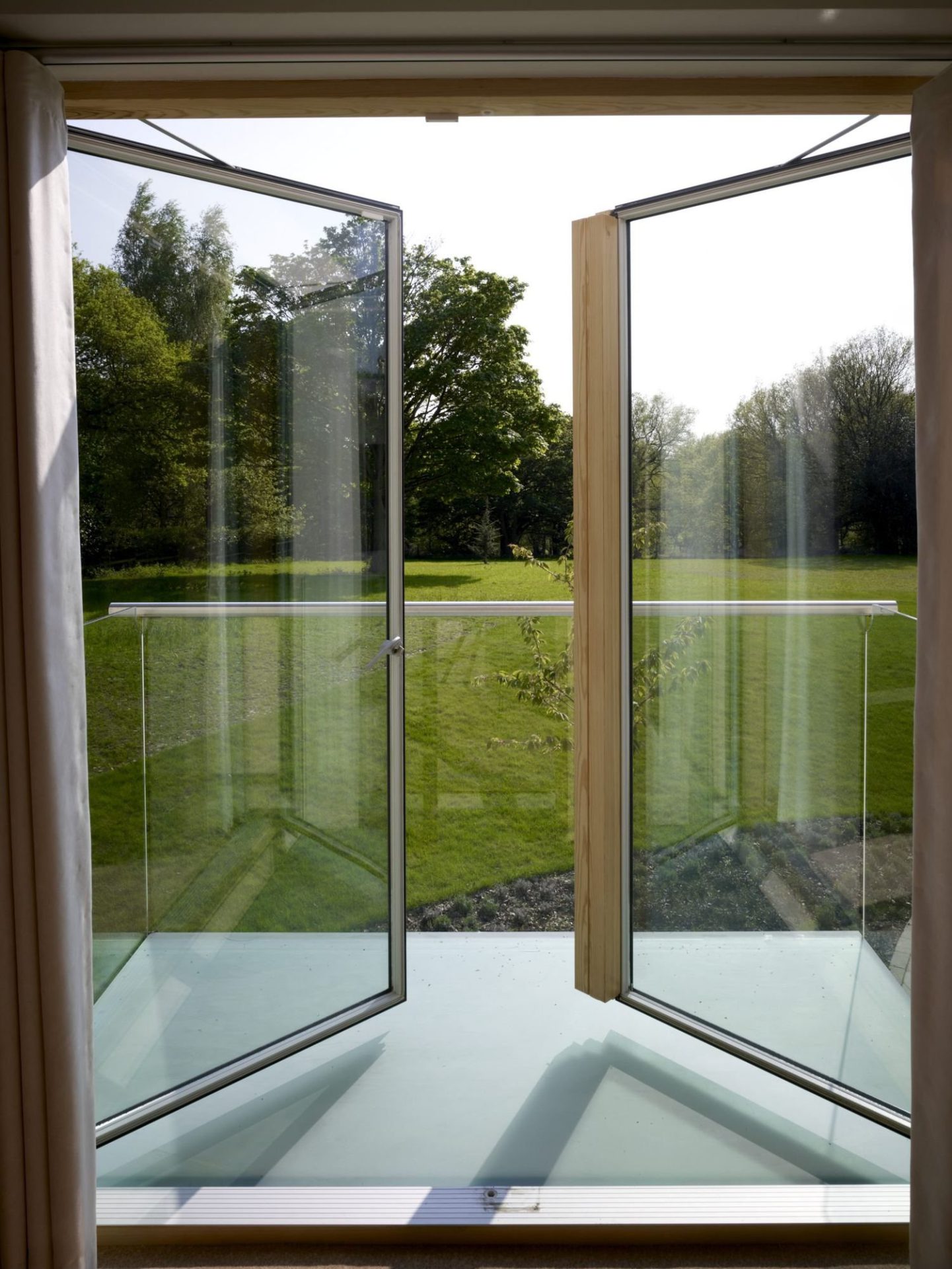 Clear lacquered timber frame around open VELFAC 200 doors