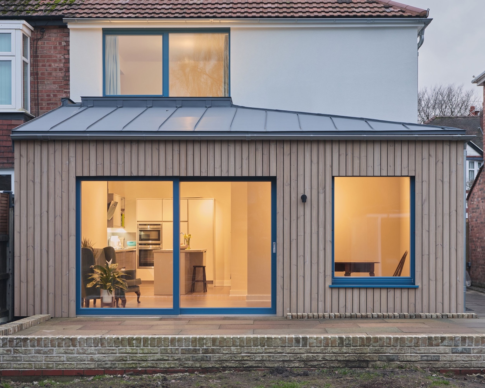 The rear of Park Haus at dusk, lit behind its triple glazing